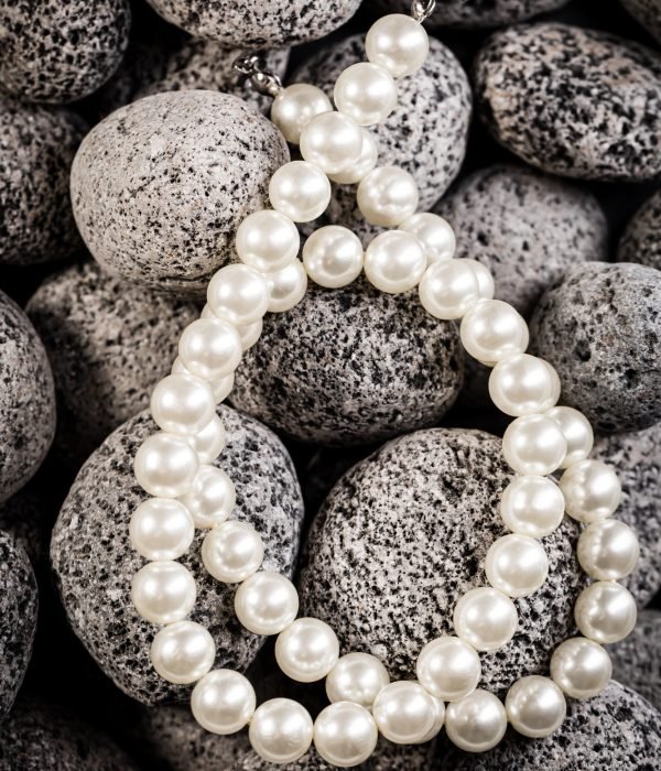 Pearl necklaces on grey stones